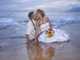 couple in water at maui wedding